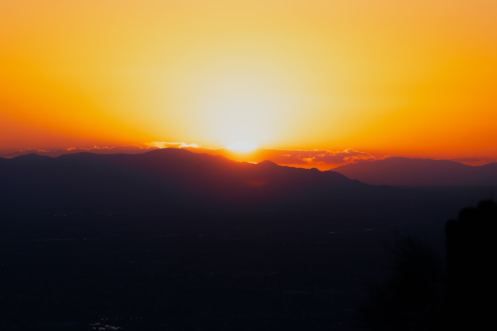 a sunset over a mountain range