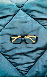 a pair of glasses on a bed