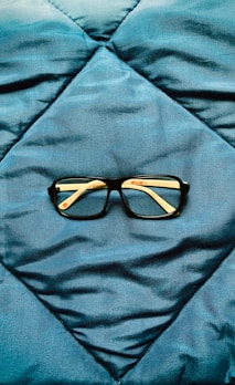 a pair of glasses on a bed