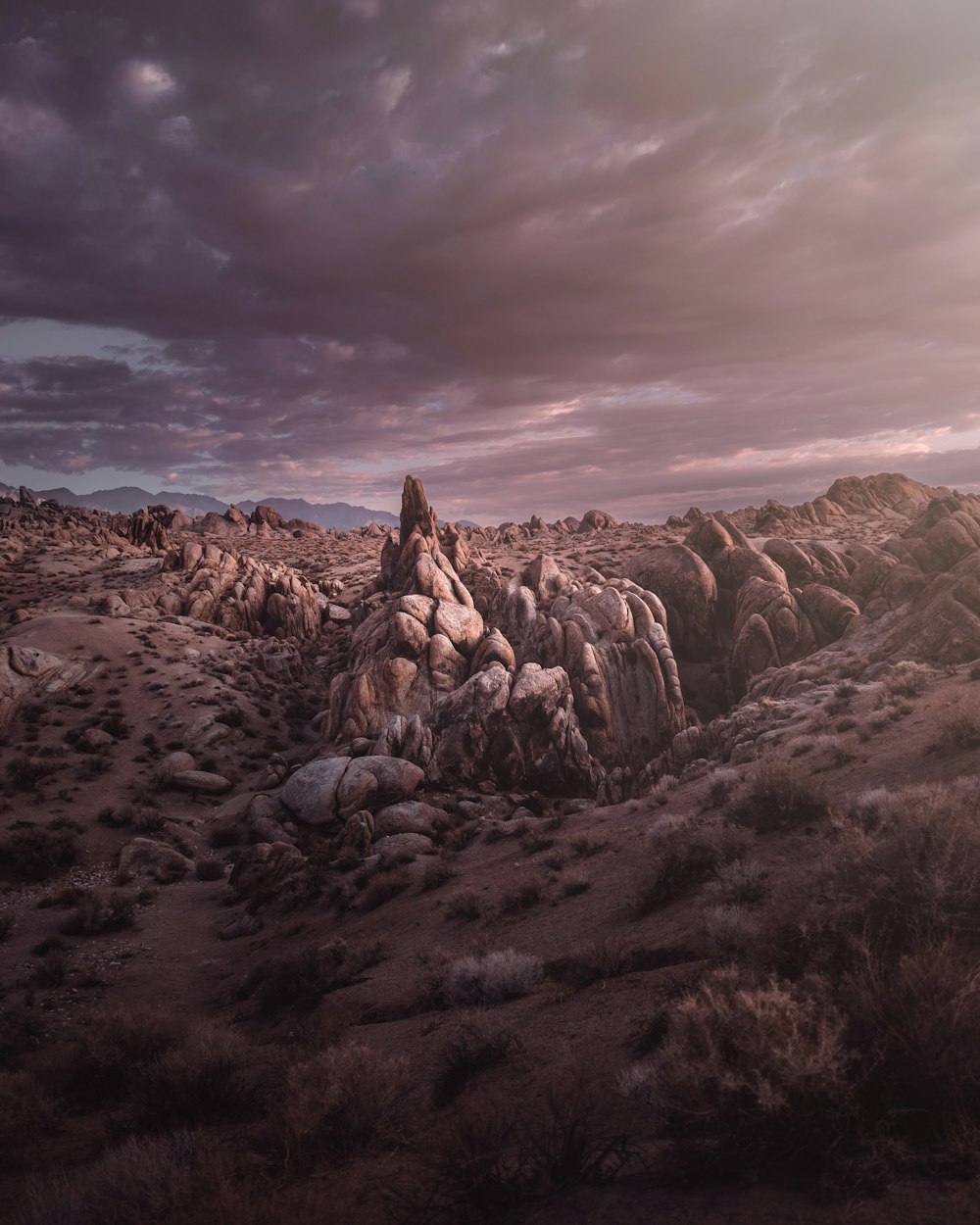 a rocky mountain with a cloudy sky