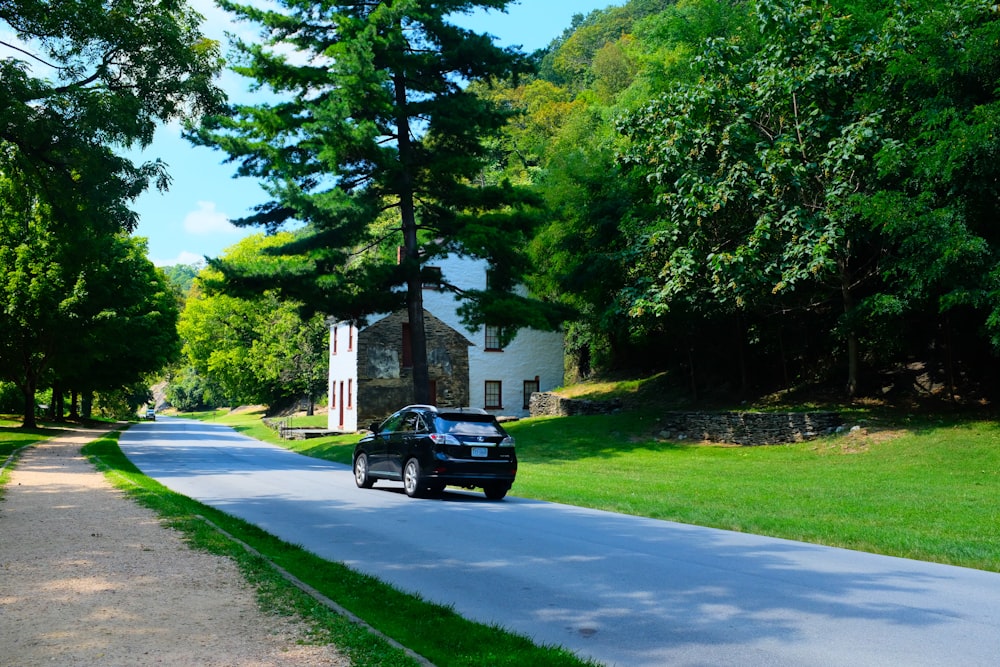 a black car parked on the side of a road