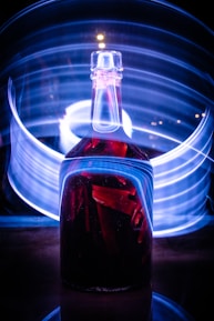 Close-up of a futuristic vial filled with pulsating red liquid labeled 'XRP Rewards' against a dark background.