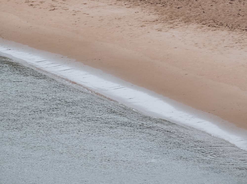 a sandy beach with waves