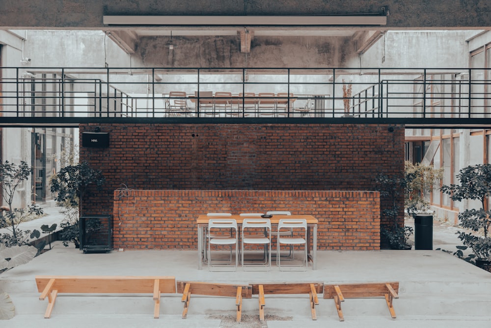 a brick building with a few chairs in front of it