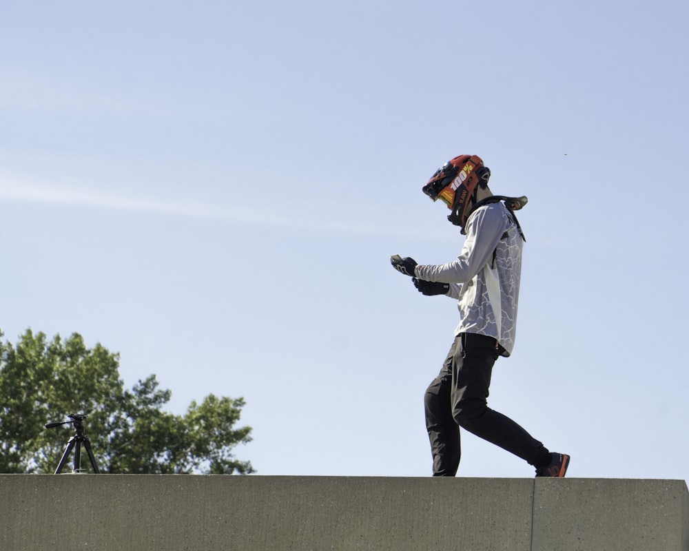 a man wearing a mask and jumping on a roof