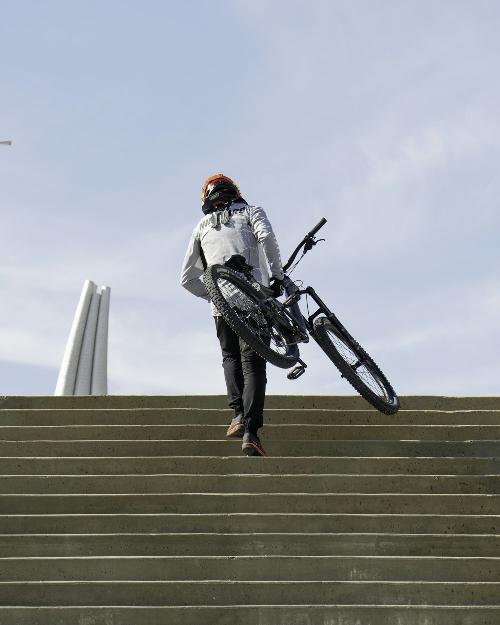 a man jumping off a roof with a bike