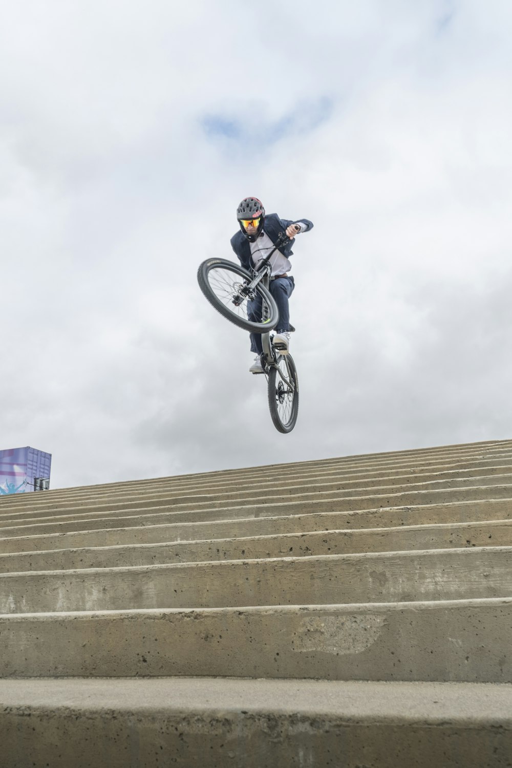 a person on a bike jumping over a ramp