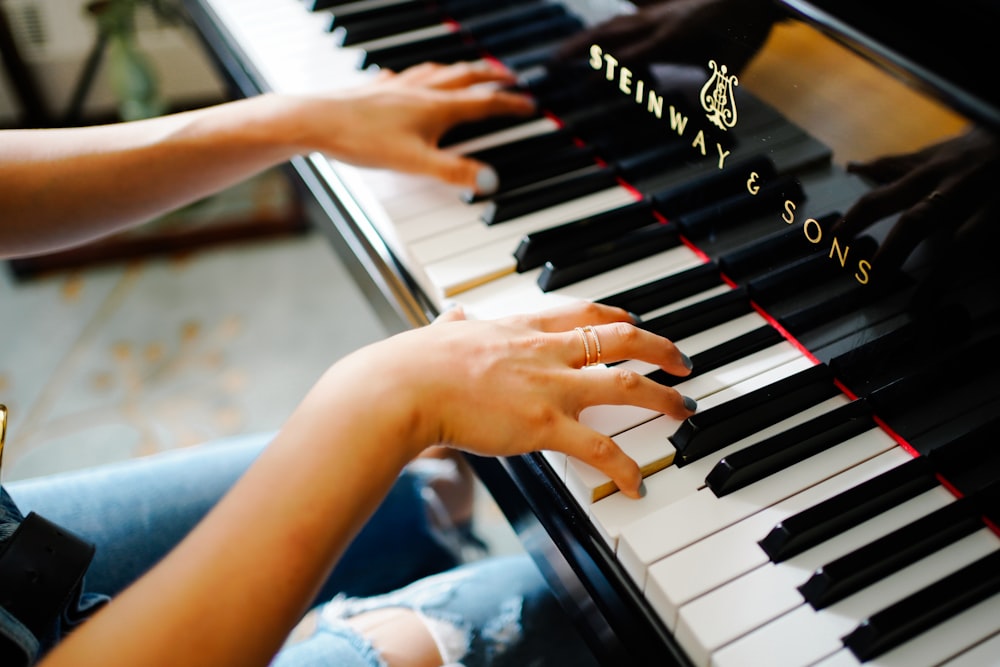 hands playing a piano