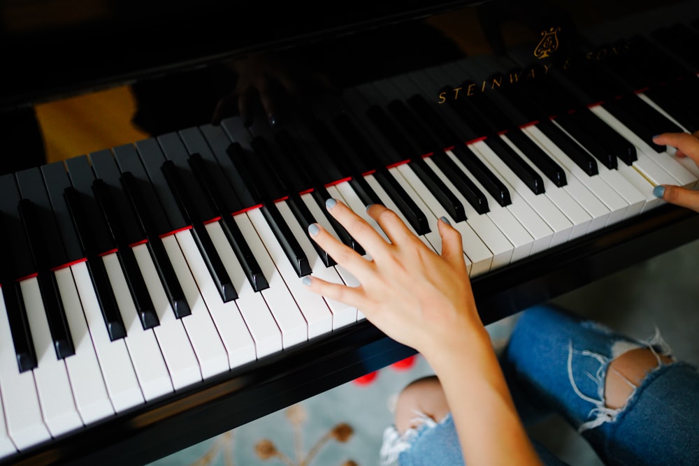 hands playing a piano