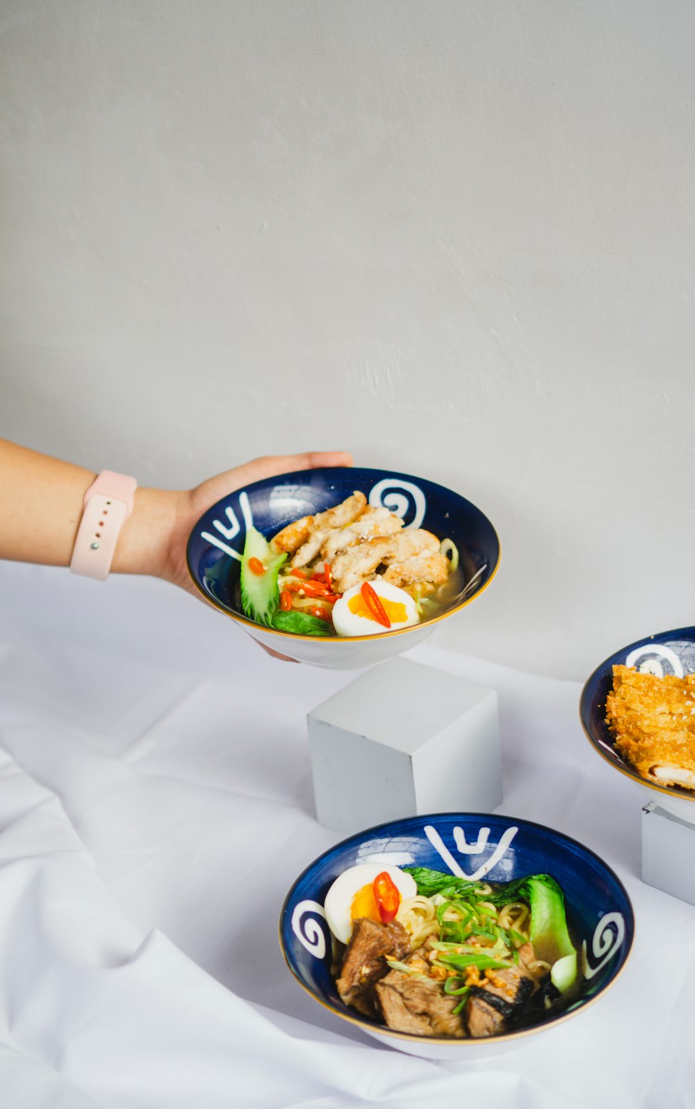 a hand holding a bowl of food