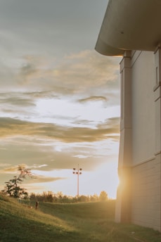 A serene plot of land near Lulu Mall, Lucknow, bathed in golden sunset light.