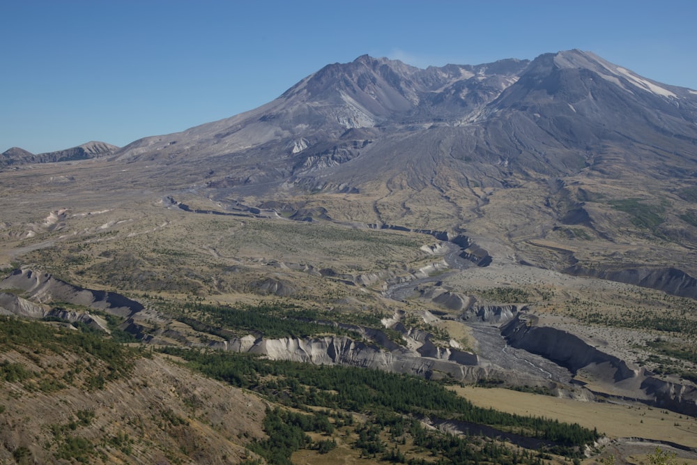 a valley with mountains in the background