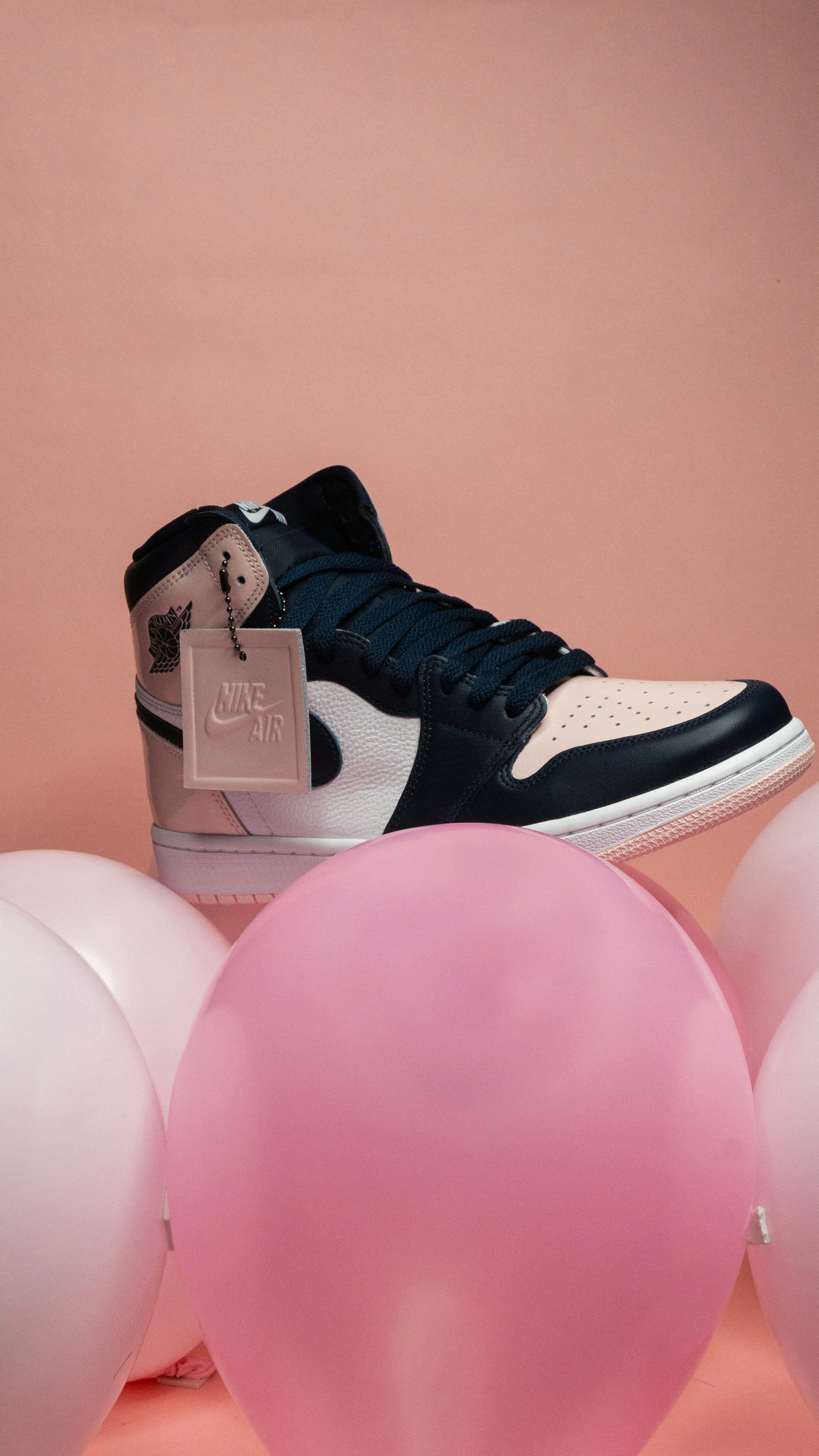 a pair of shoes on a pink balloon