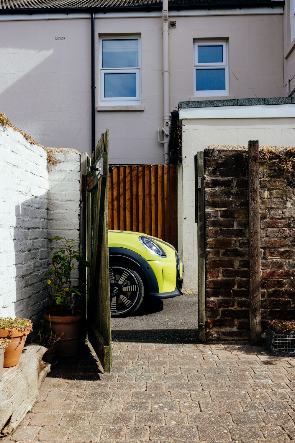 a yellow car parked in front of a house