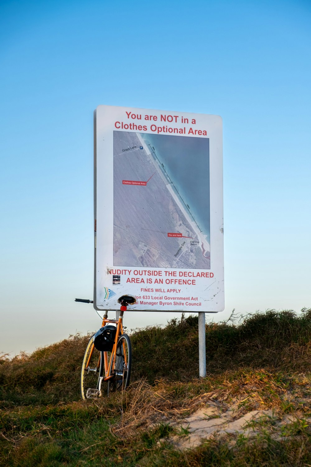 a sign with a bicycle in front of it