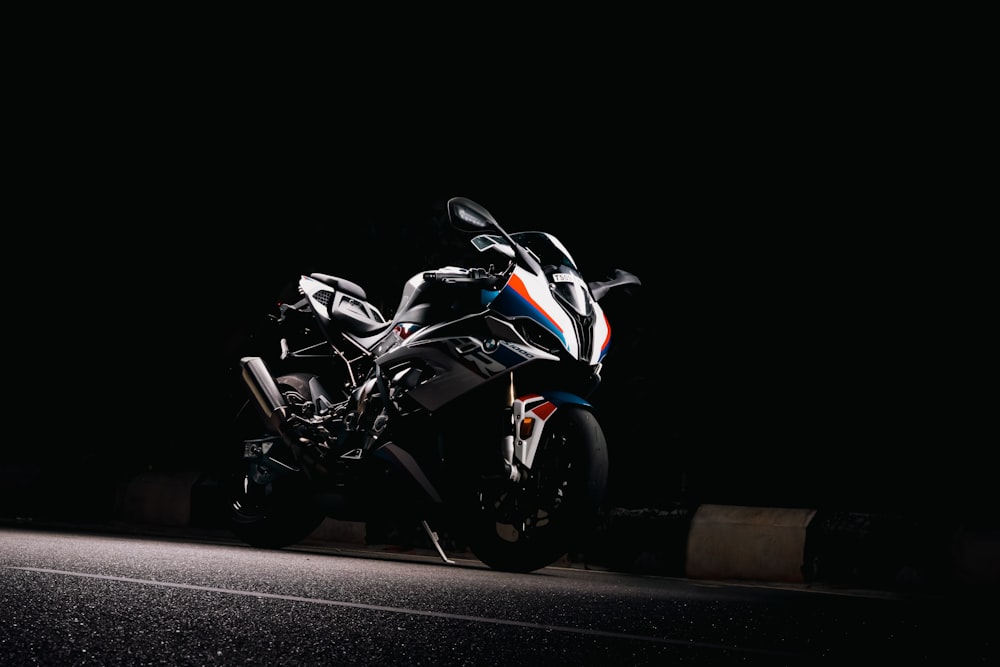 a motorcycle parked on the side of a road at night