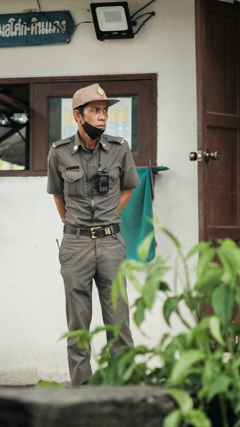 a man wearing a hat and a phone to his ear