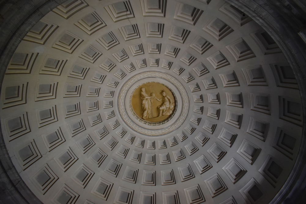 a circular ceiling with a gold coin