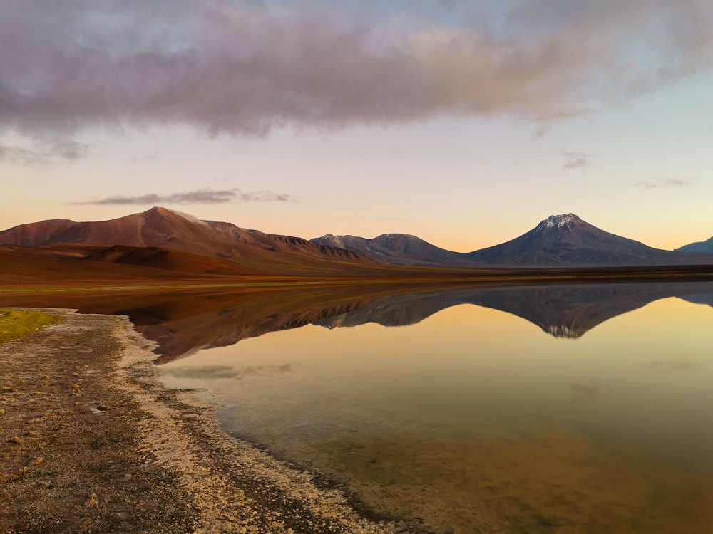 a body of water with mountains in the background