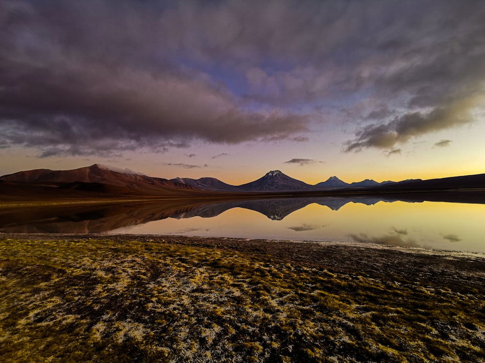 a body of water with hills in the background