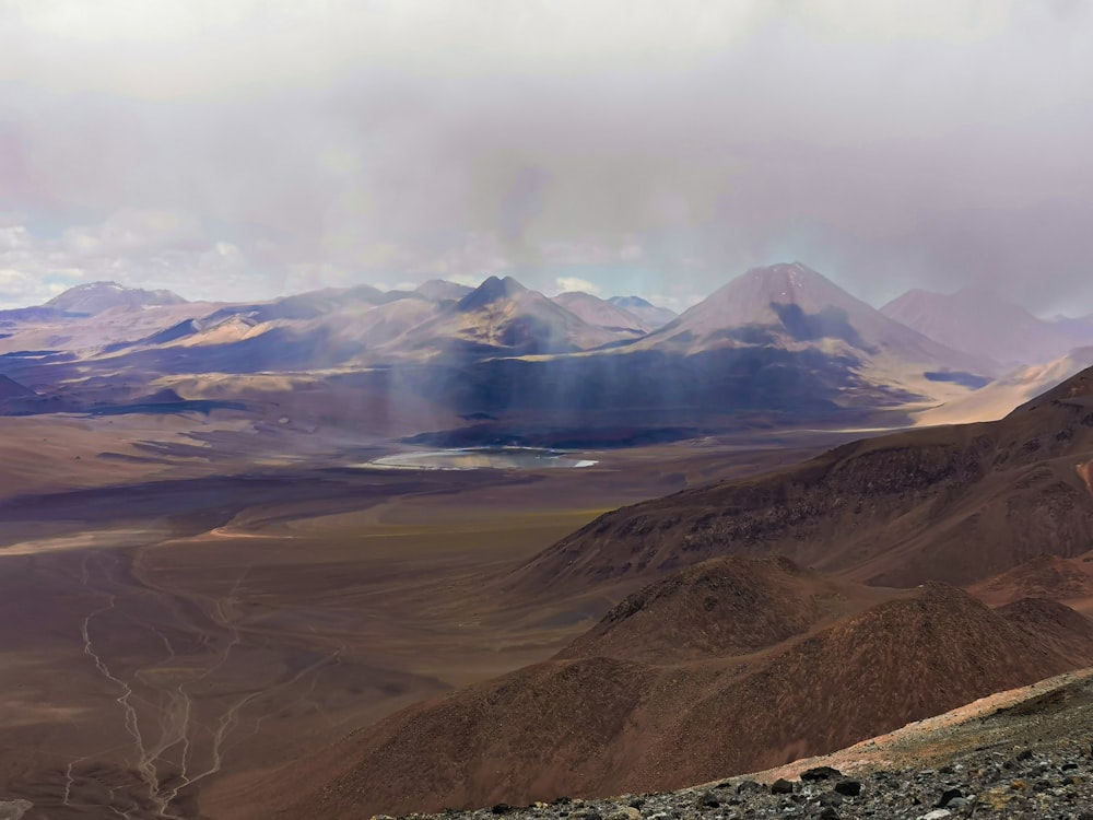 a valley with mountains in the background