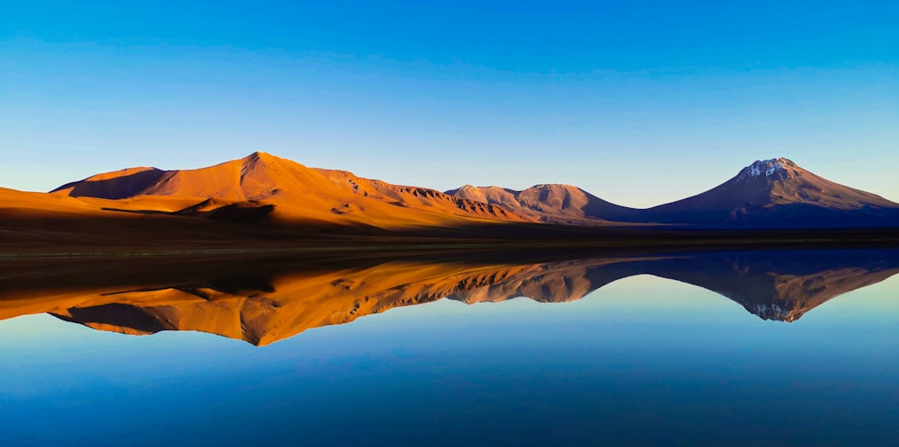 a body of water with mountains in the background