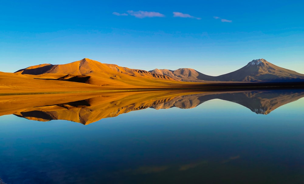 a body of water with mountains in the background