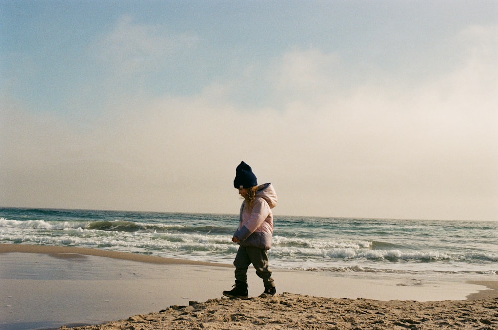 a man walking on a beach