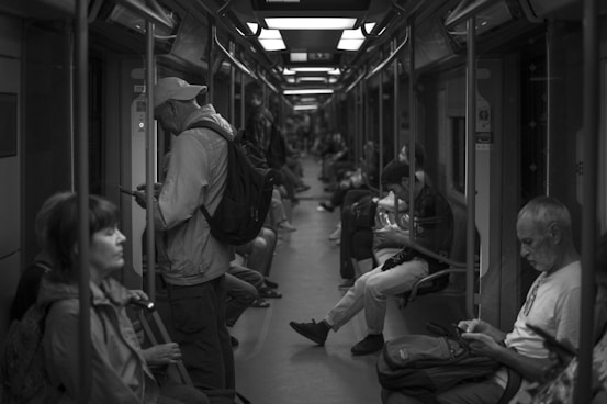 a group of people sitting at a train station