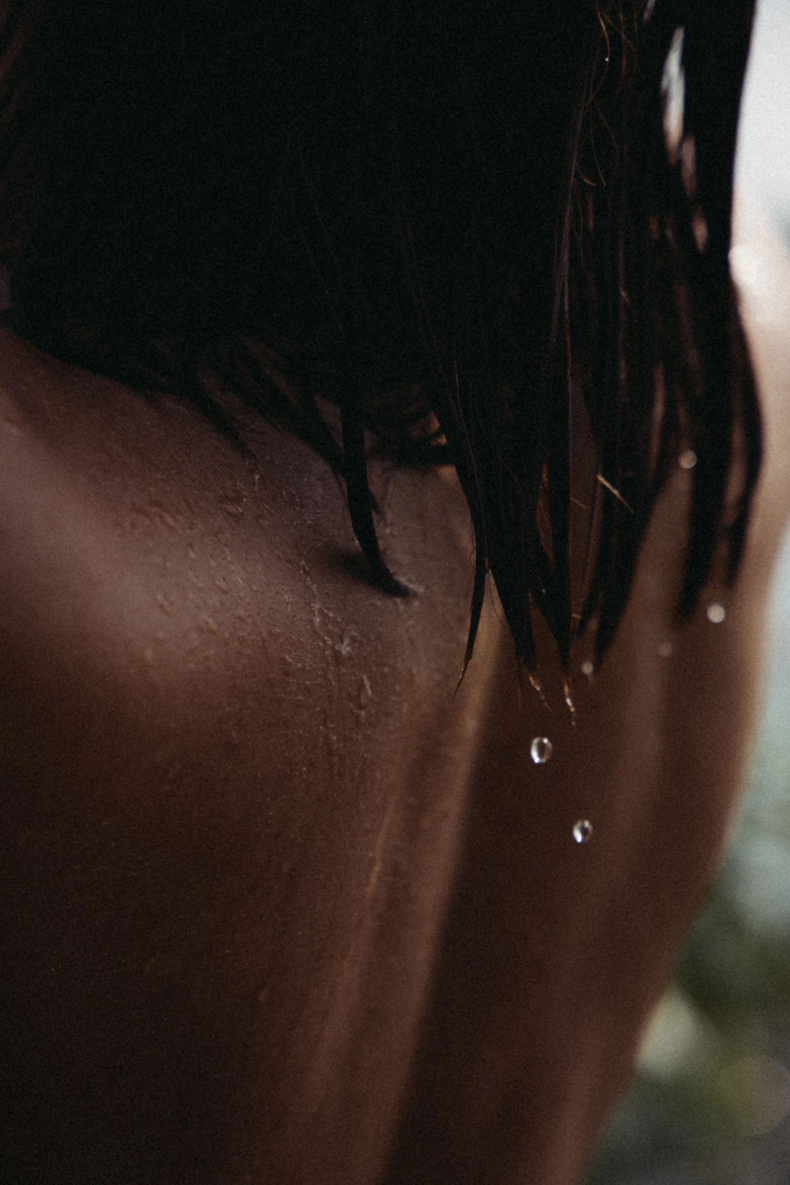 Close-up of wet skin and hair in evening light