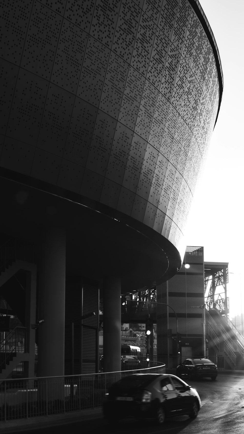 a large metal structure with a car parked in front of it