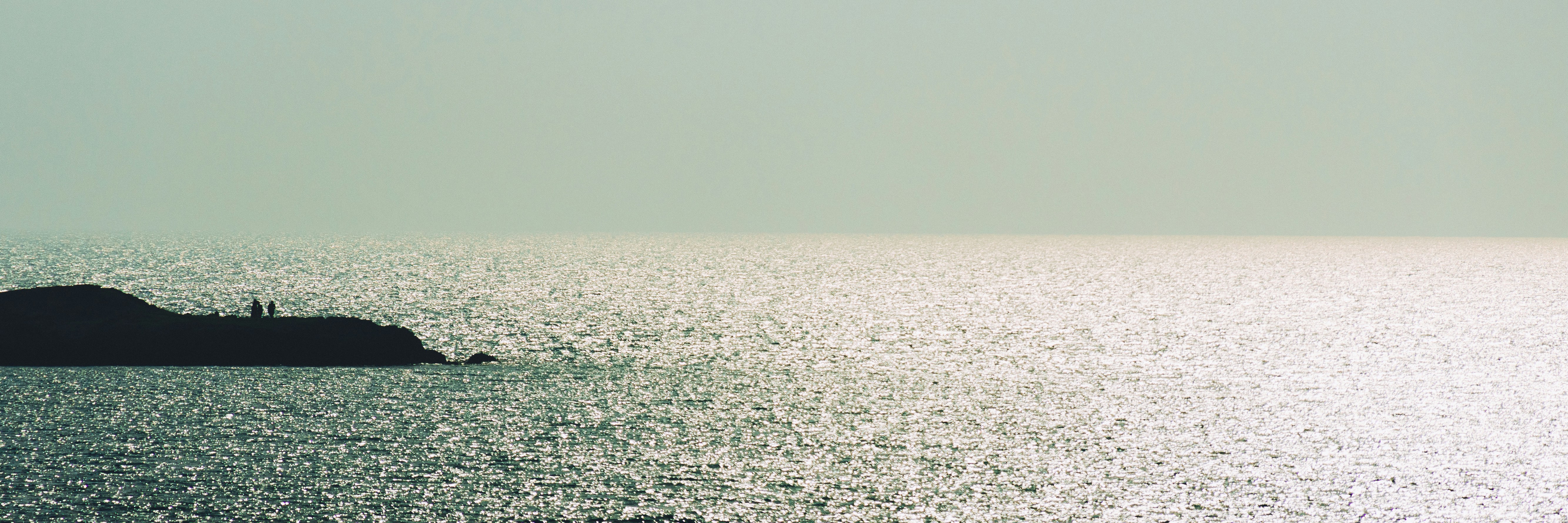 a large body of water with a rock in it
