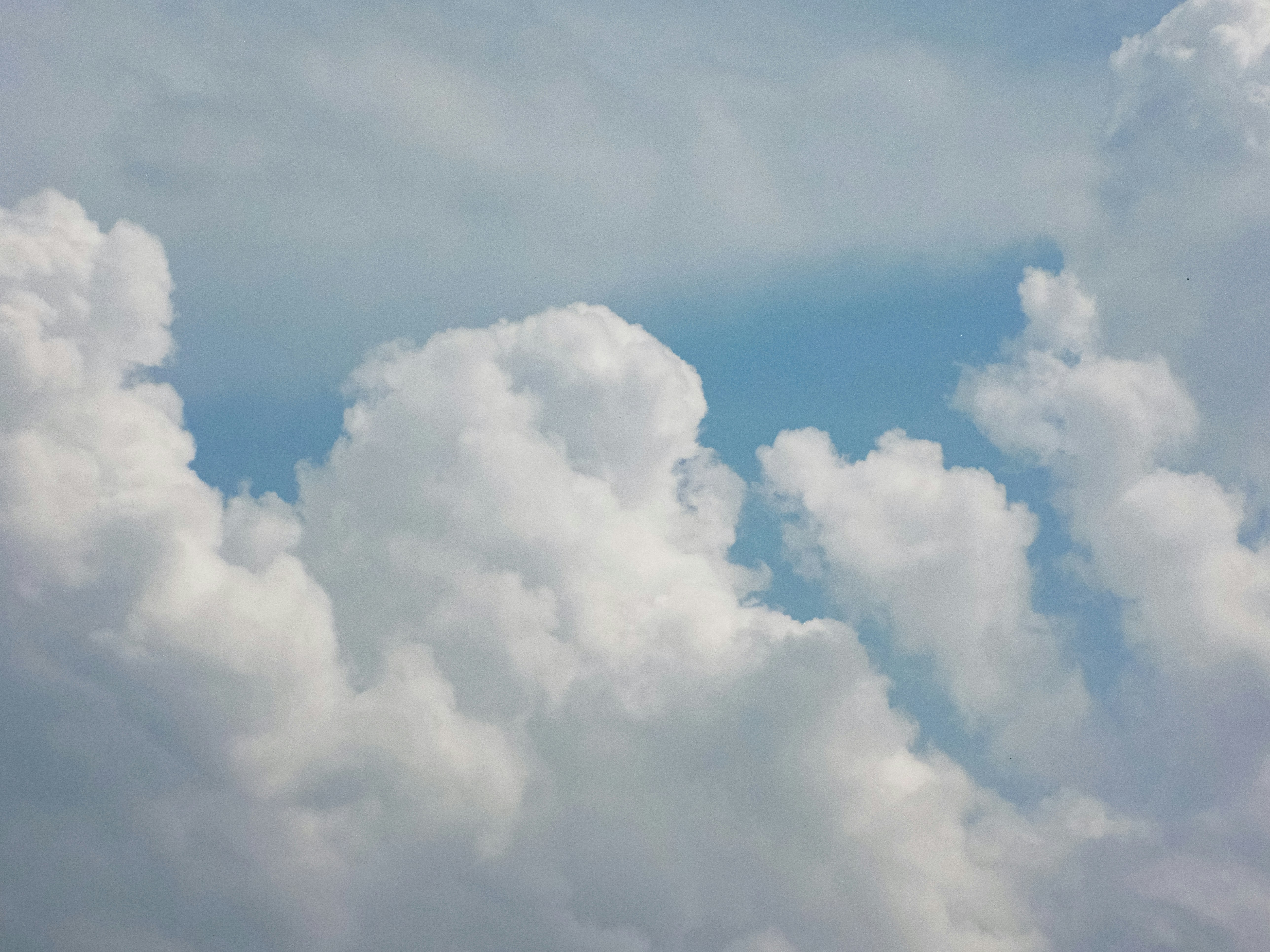 Fluffy white cumulus clouds in a blue sky