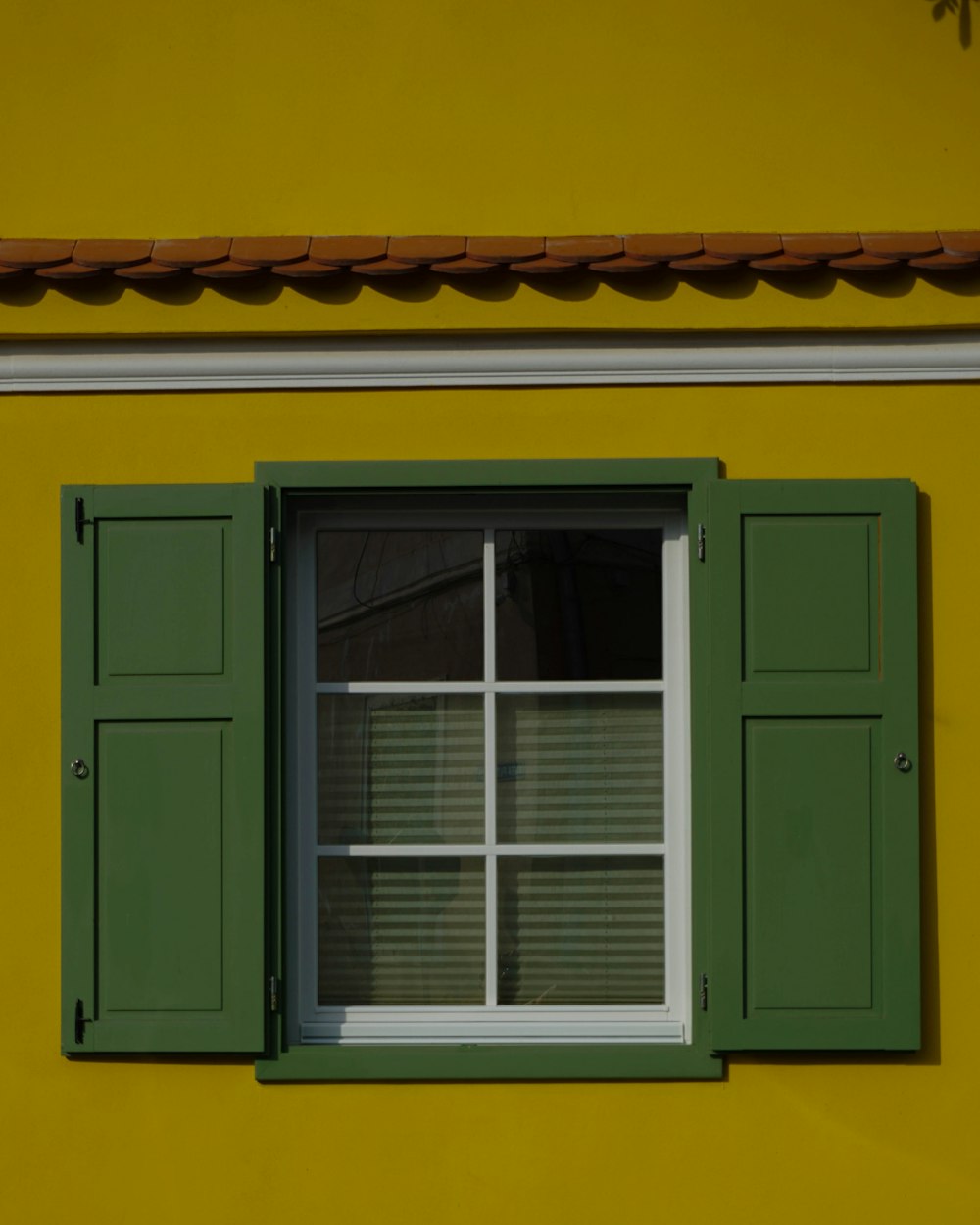 a window with a green shutter
