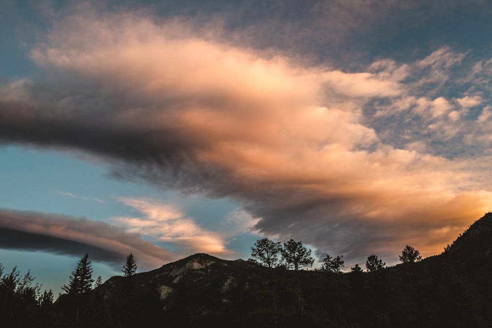 a cloudy sky over a mountain