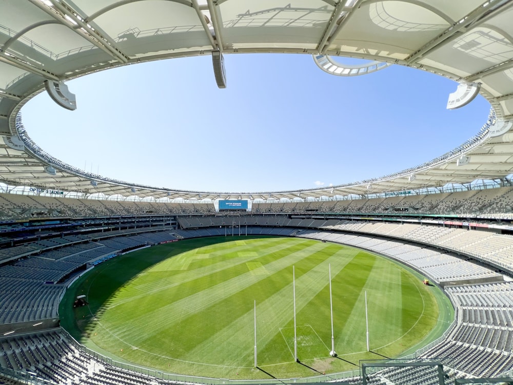 a sports stadium with a green field