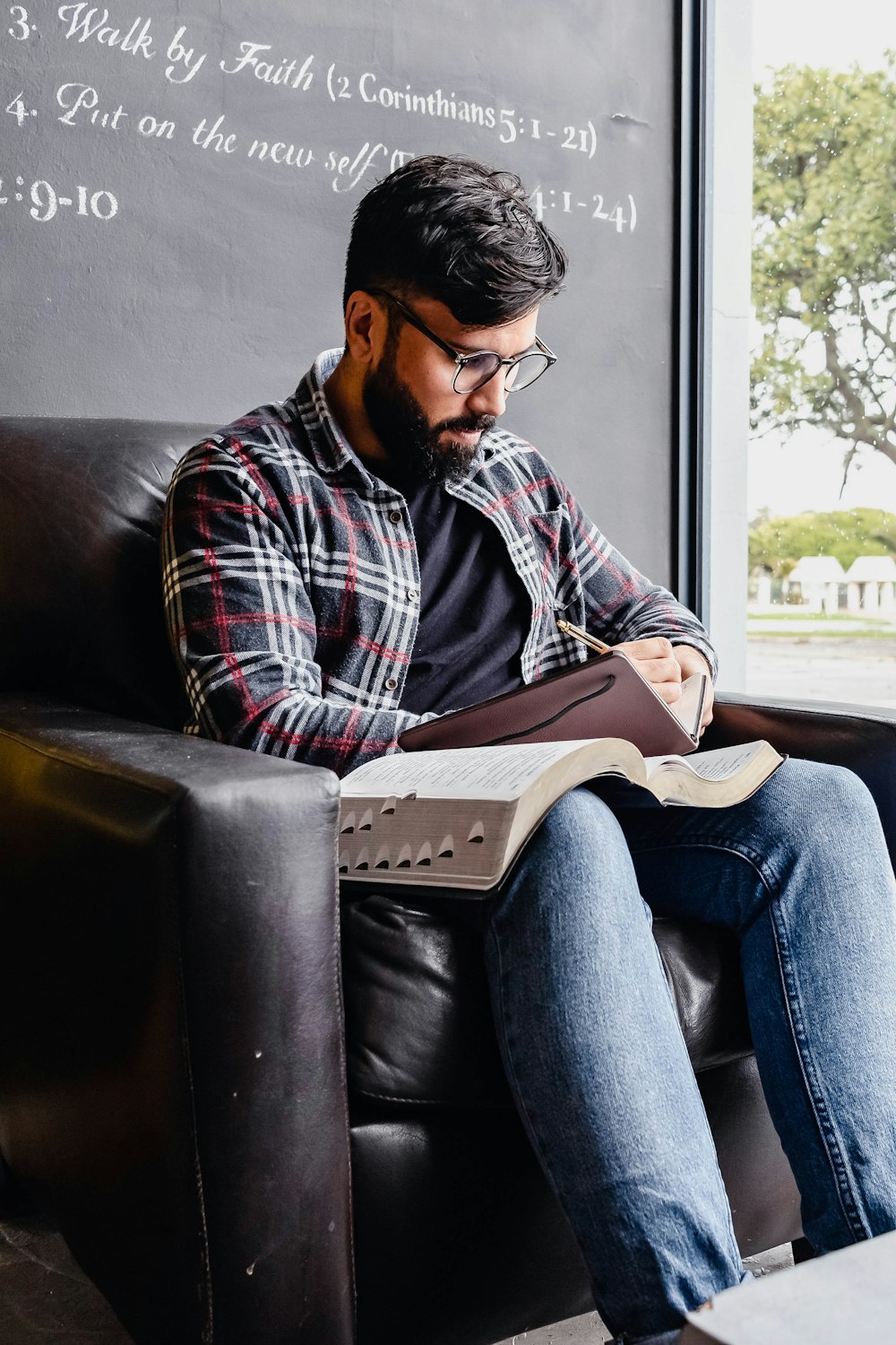 a person sitting on a couch reading a book