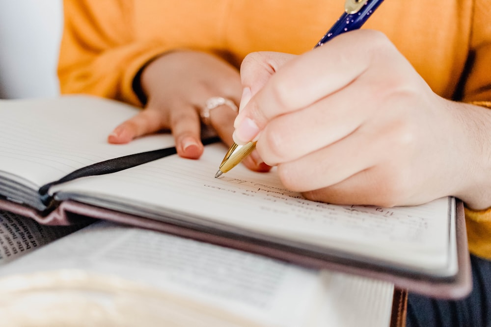 a person writing on a book