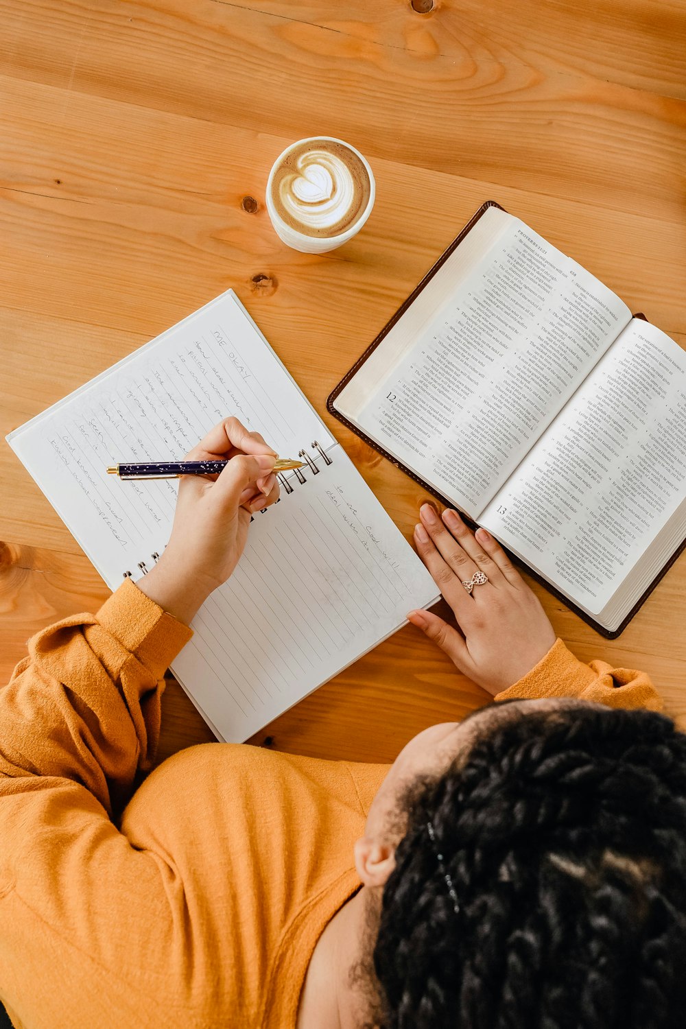 a person writing on a book