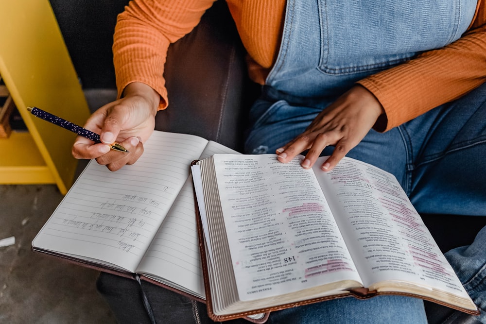 a person writing on a book