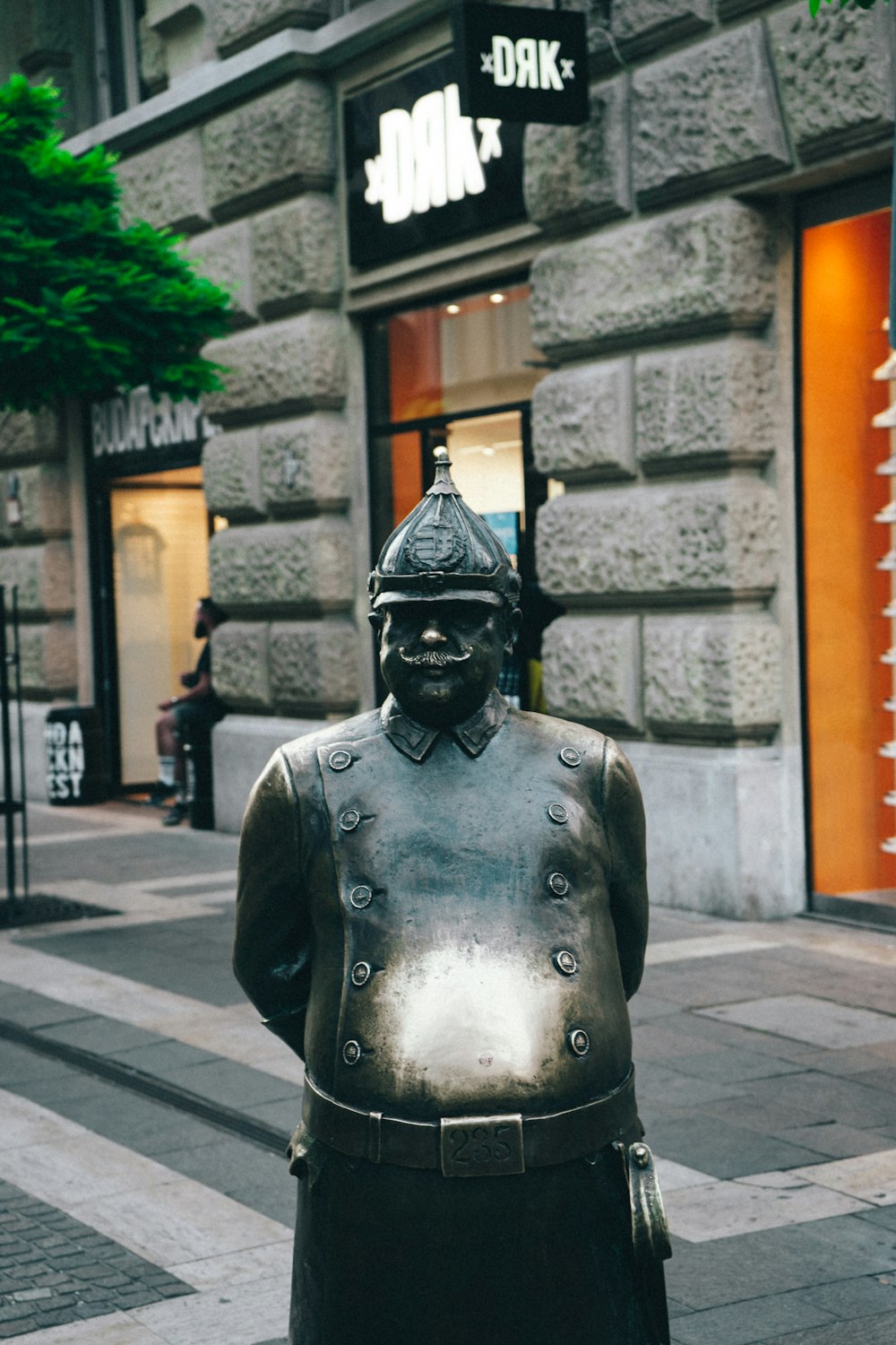 a statue of a person wearing a mask and a hat