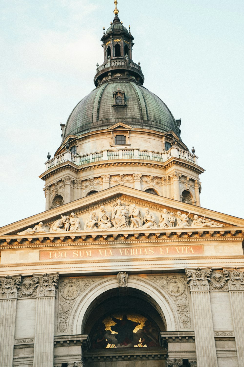 a large building with a dome and a statue in front of it