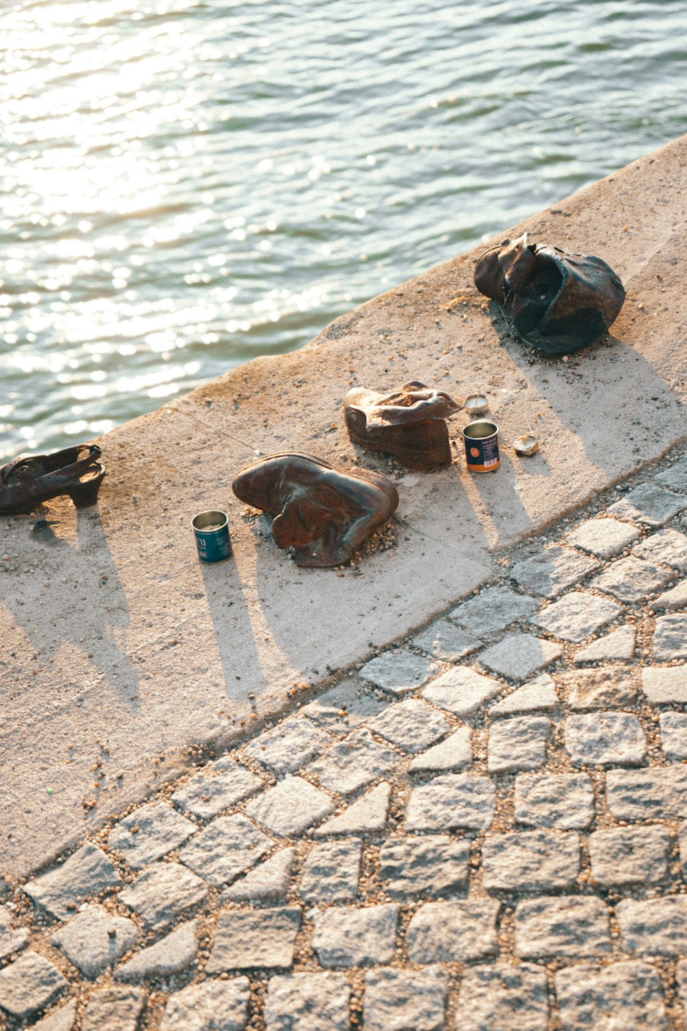 a group of objects on a brick surface by a body of water