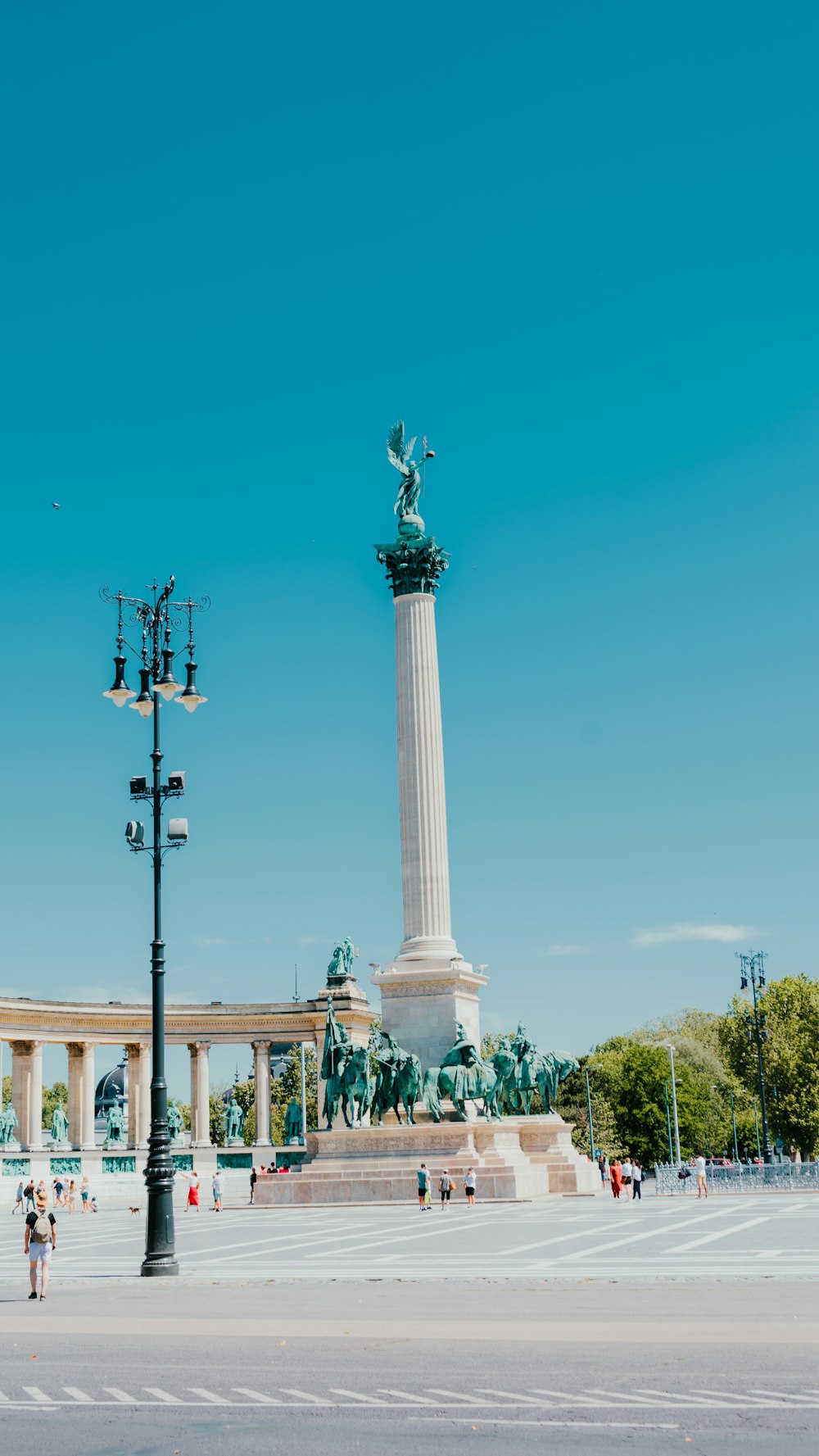 a statue of a person holding a torch in front of a monument