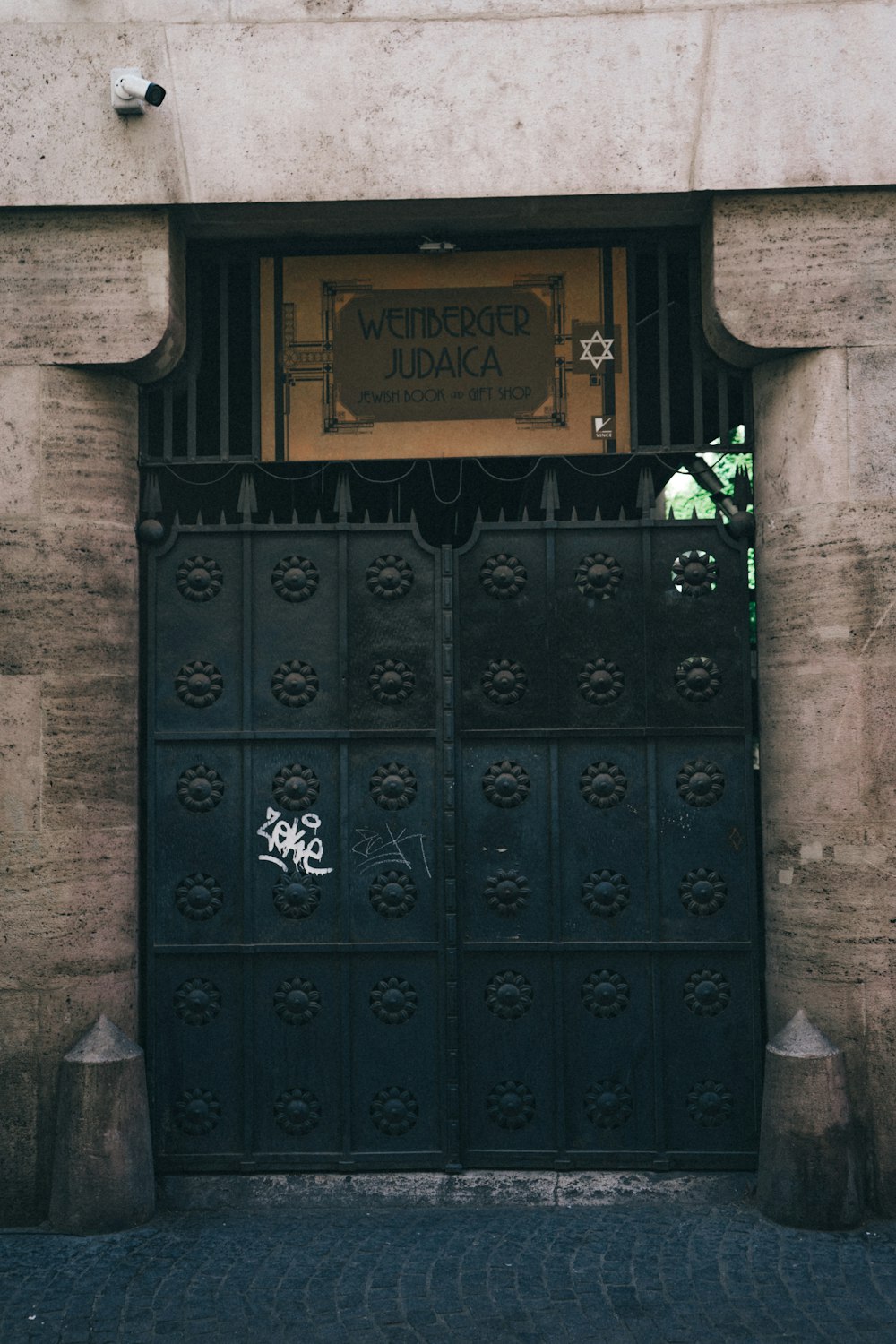 a black gate with a sign on it