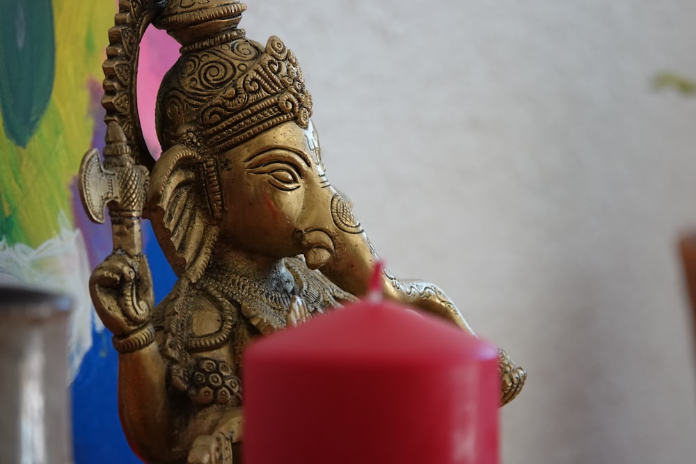 a statue of a person holding a red object