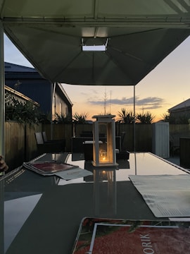 A peaceful patio area with garden lighting glowing at dusk