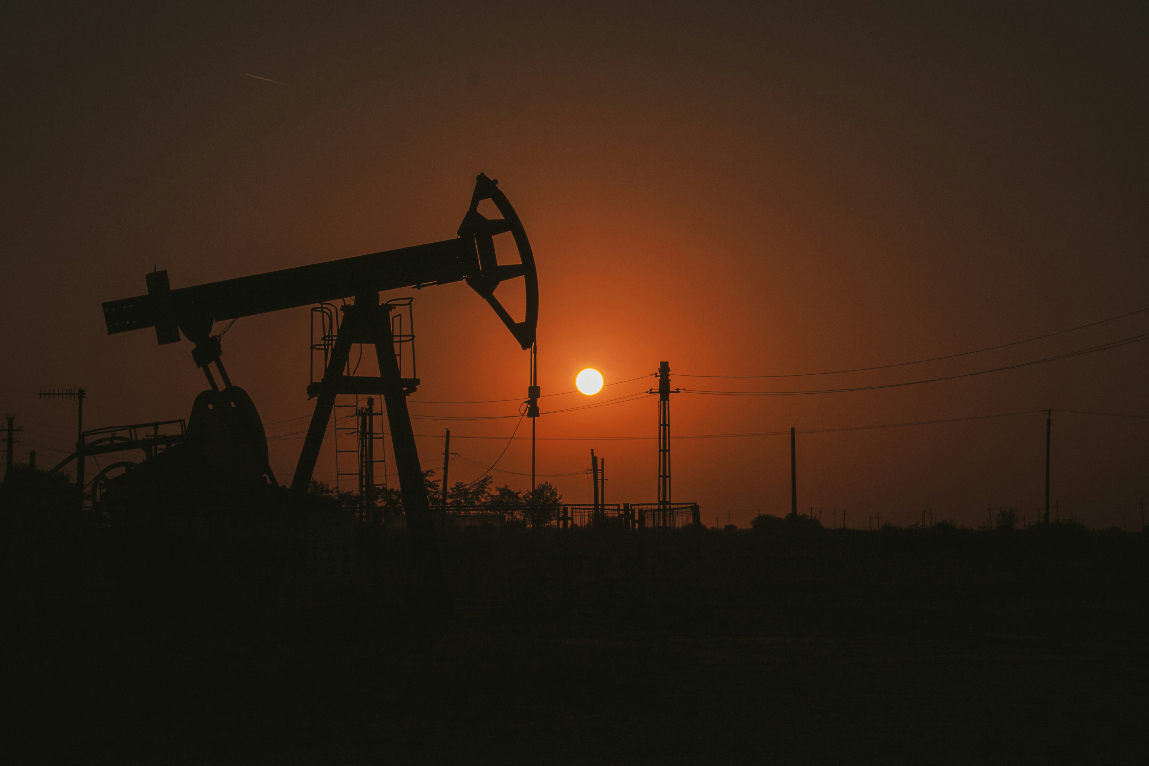 An aerial view of an oil field at sunset.