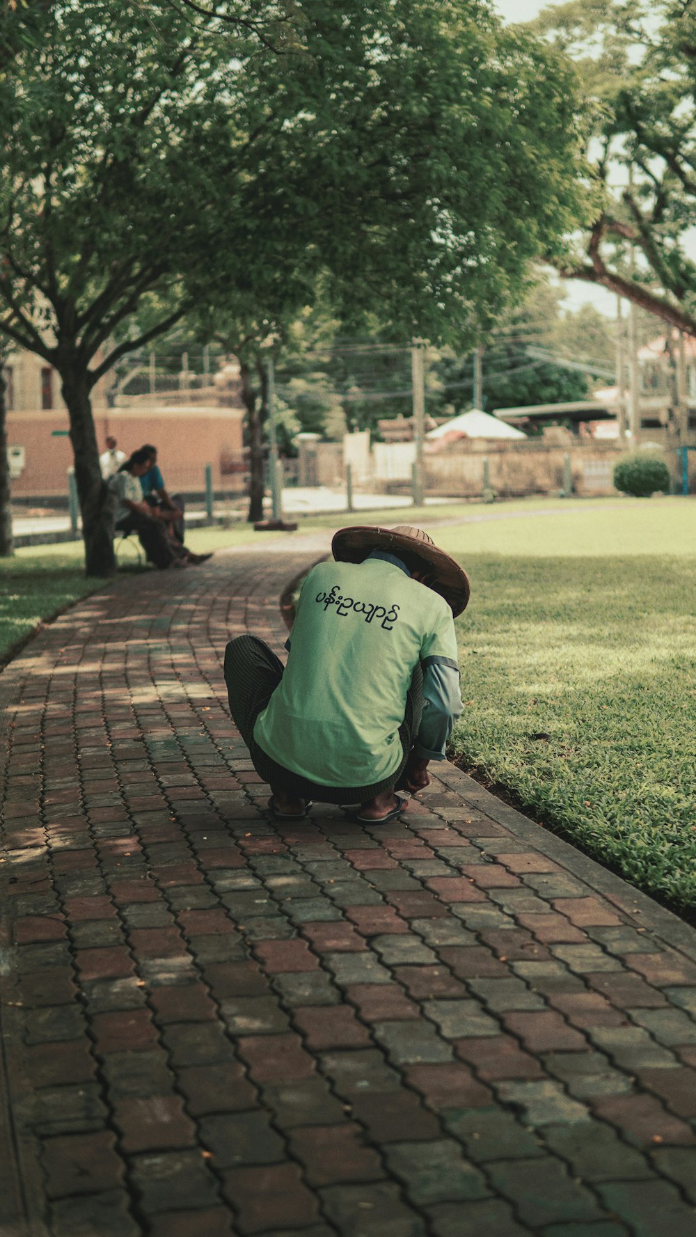a person bending over on a brick path