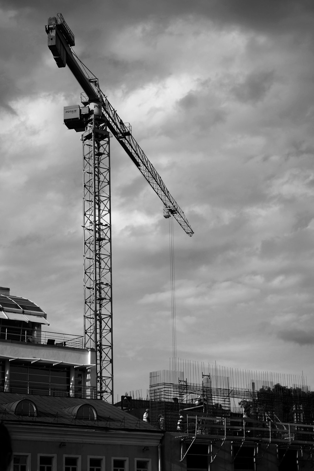 a crane next to a building